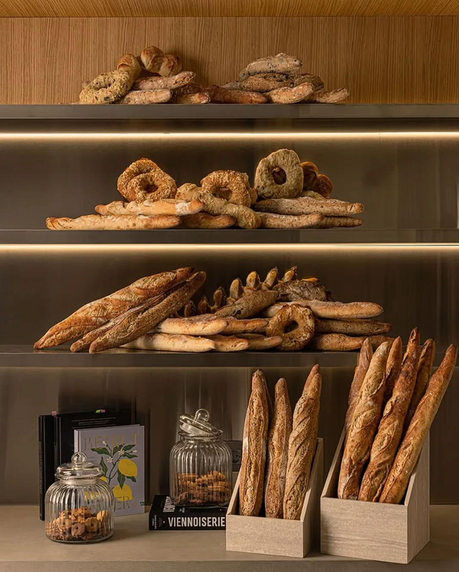 Shelves of fresh baguettes, bagels and artisan breads at Muscador