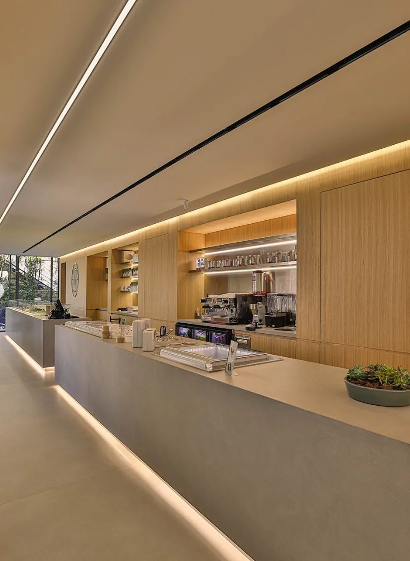 The Muscador boutique interior with warm wood, soft lighting and the M emblem